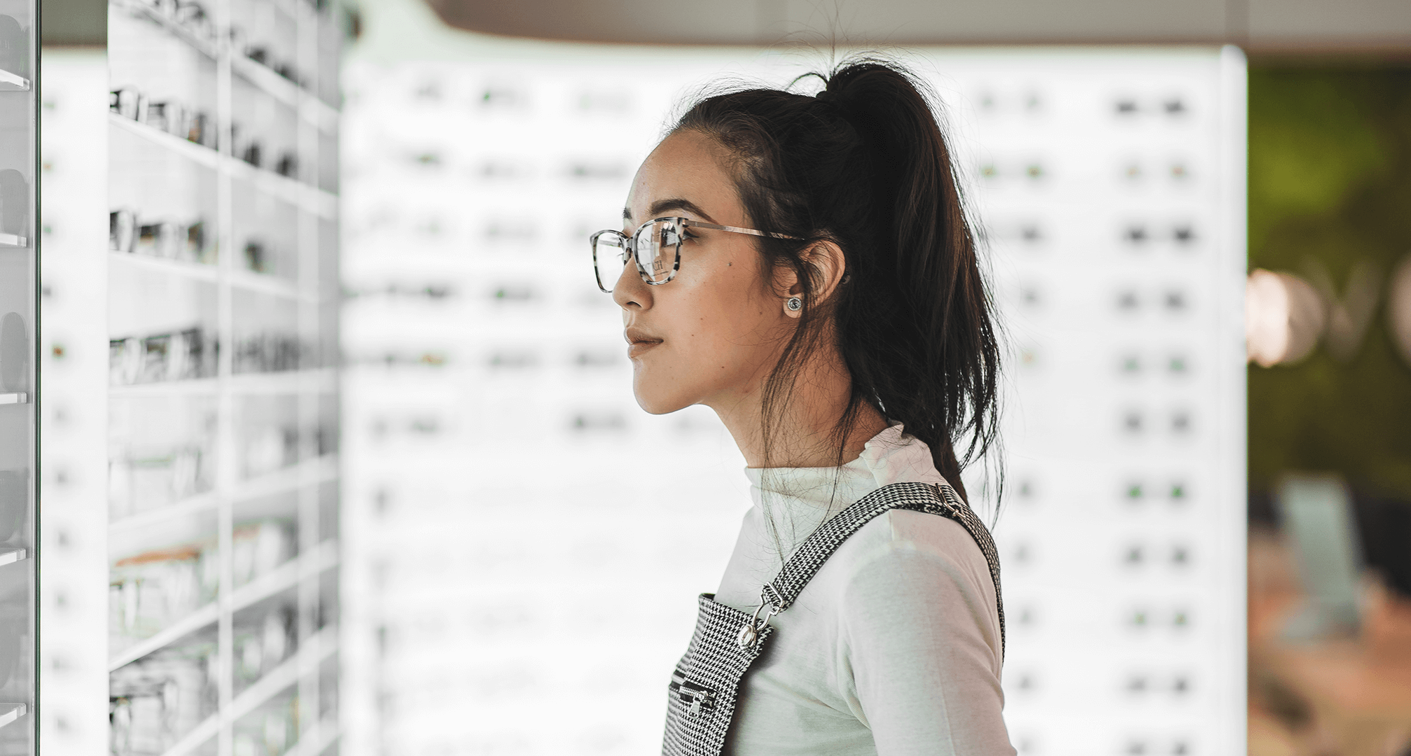person looking for glasses on display