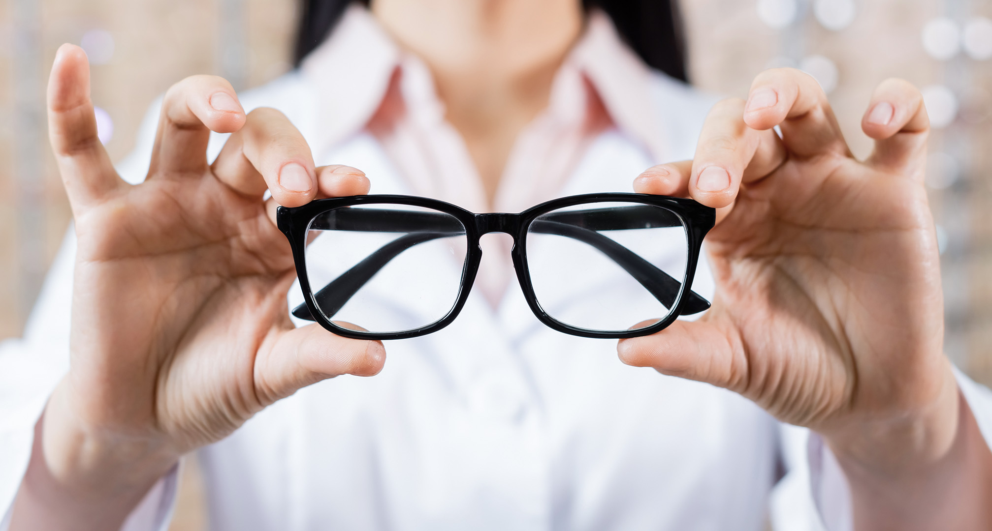 schwarze Brille in der Hand