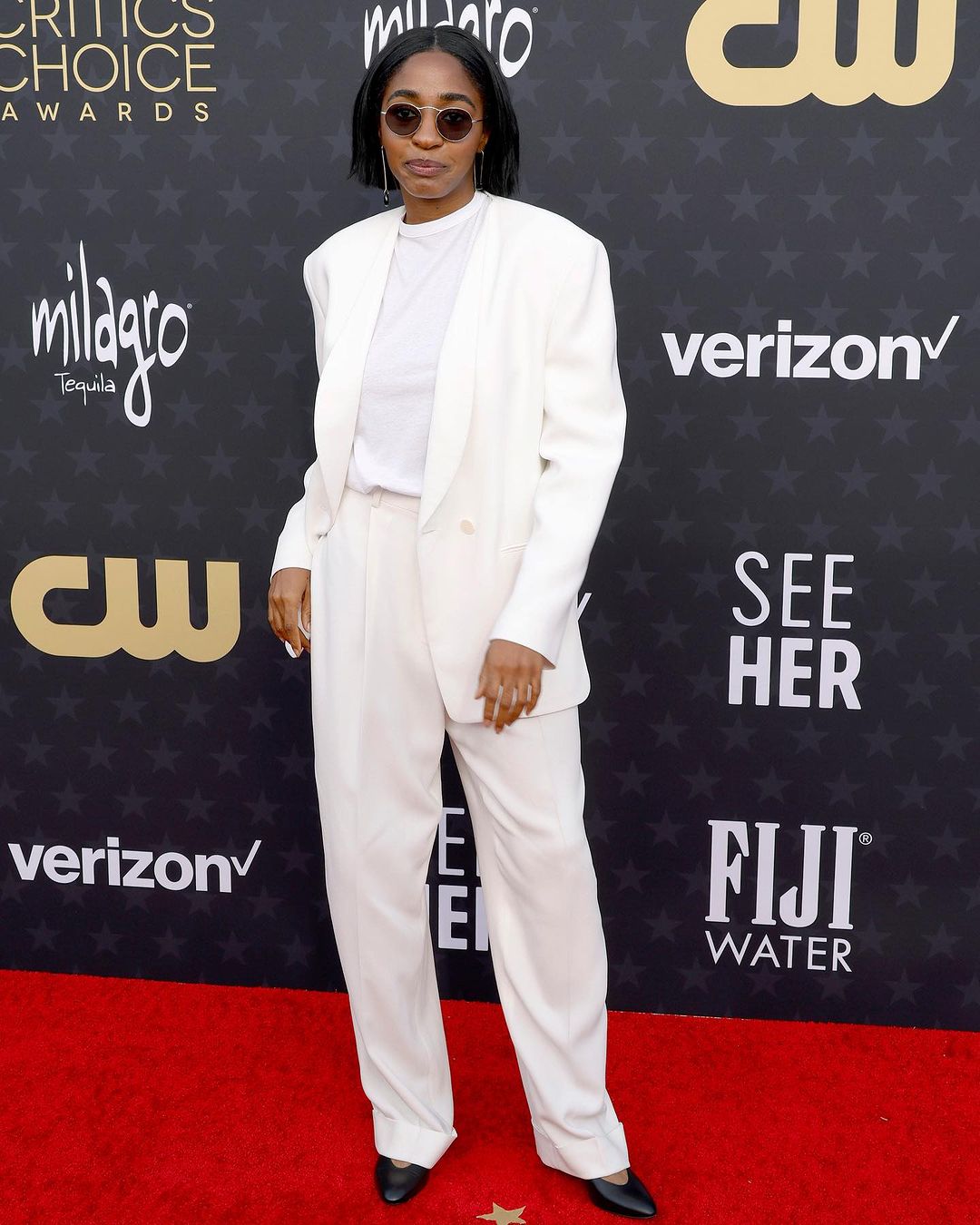 ayo edebiri en costume blanc sur le tapis rouge